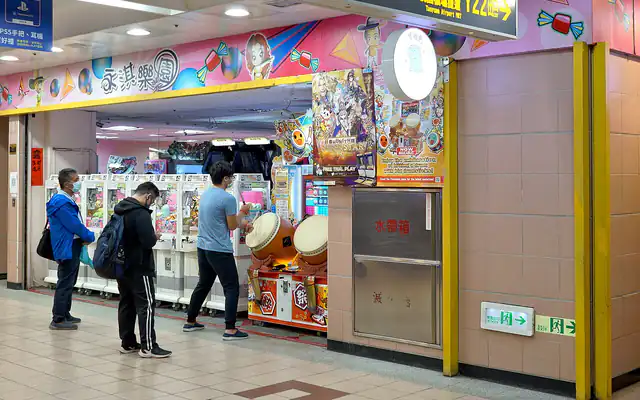 People playing arcade games at a game centre