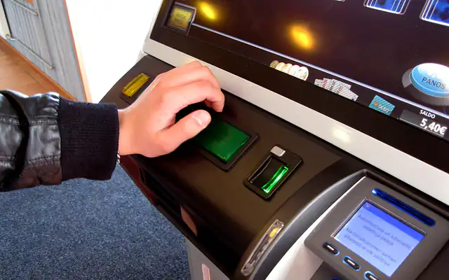 Player pressing the spin button on a video slot machine